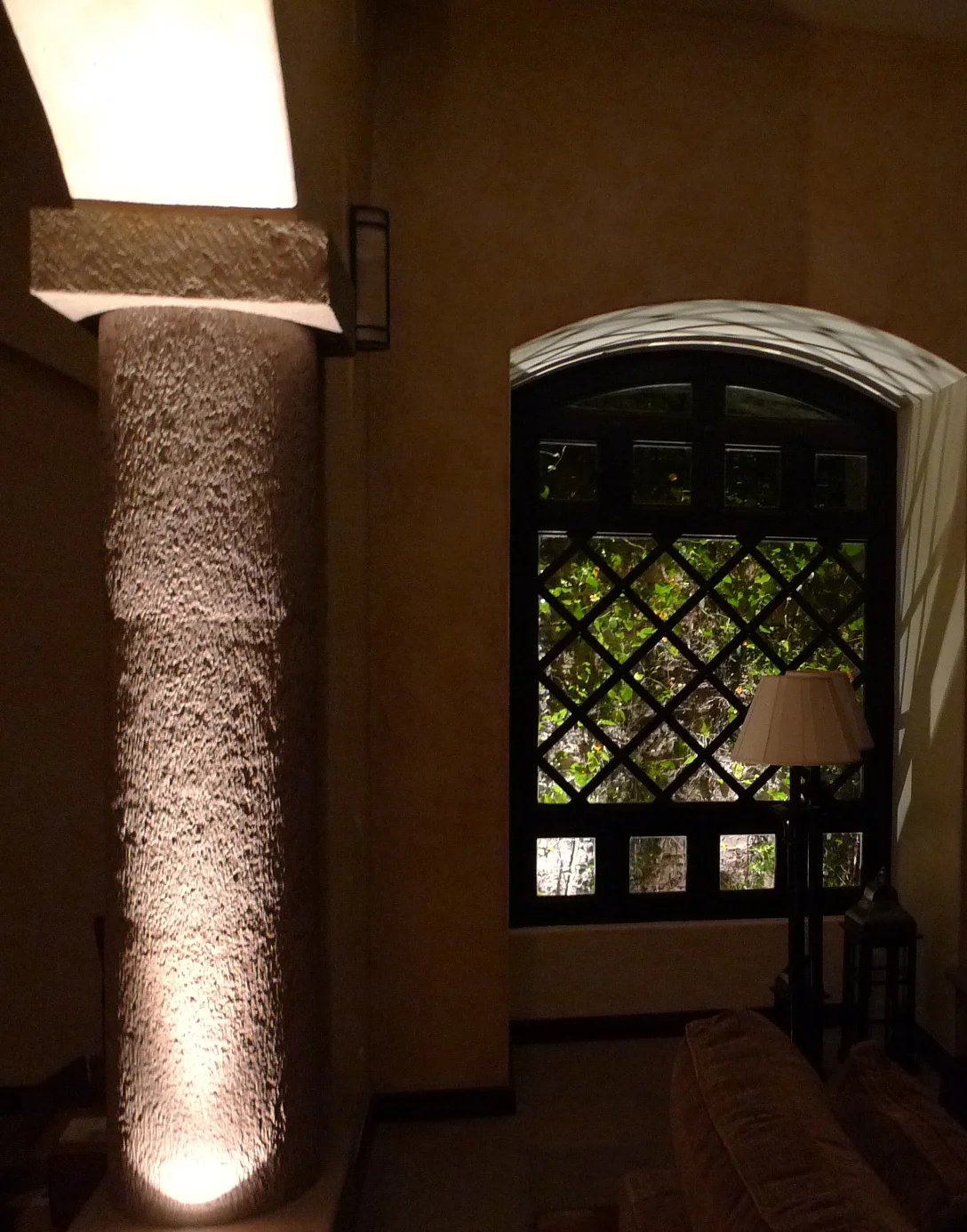 B Residence entry — a grazing light reveals a chiselled stone column