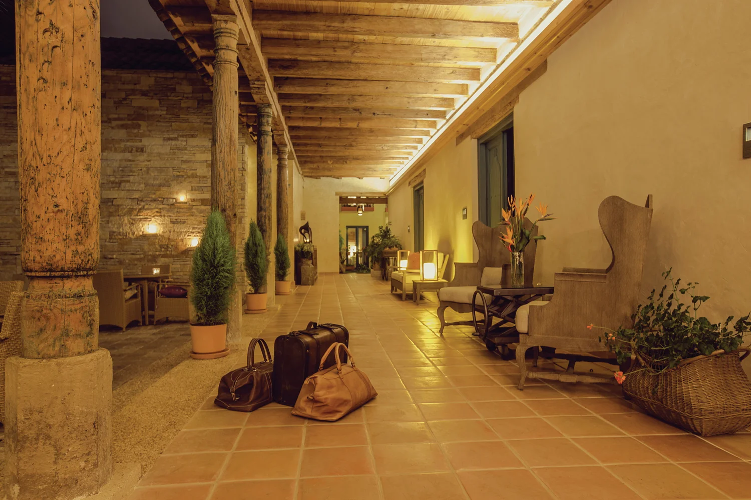 Colonnaded corridor with original stone columns and warm pooled light