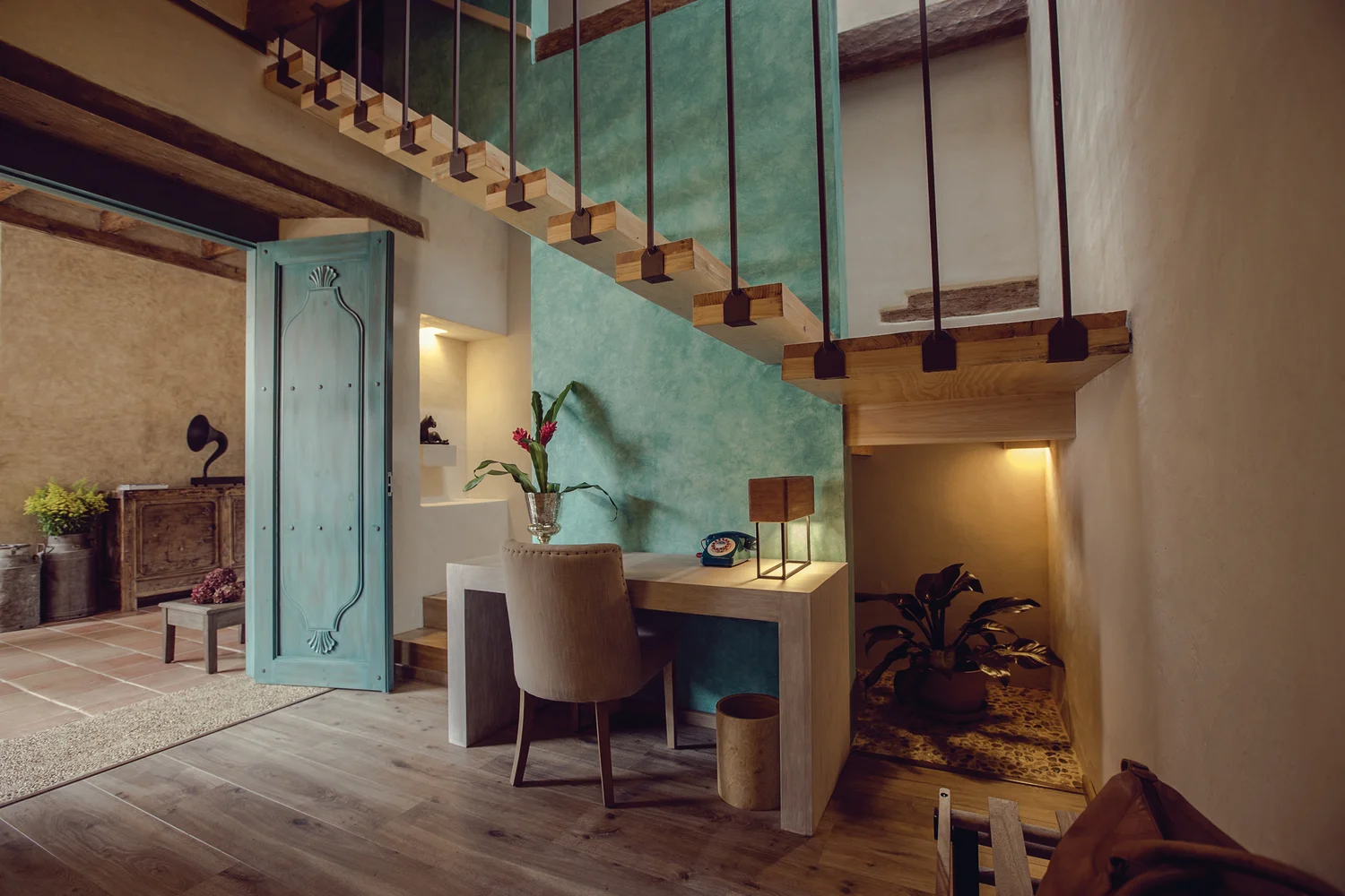 Suite with turquoise mezzanine stair and a desk niche