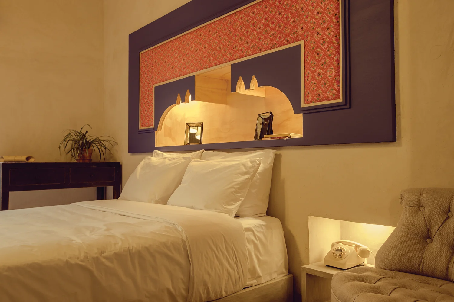 Bed with a carved, backlit headboard niche