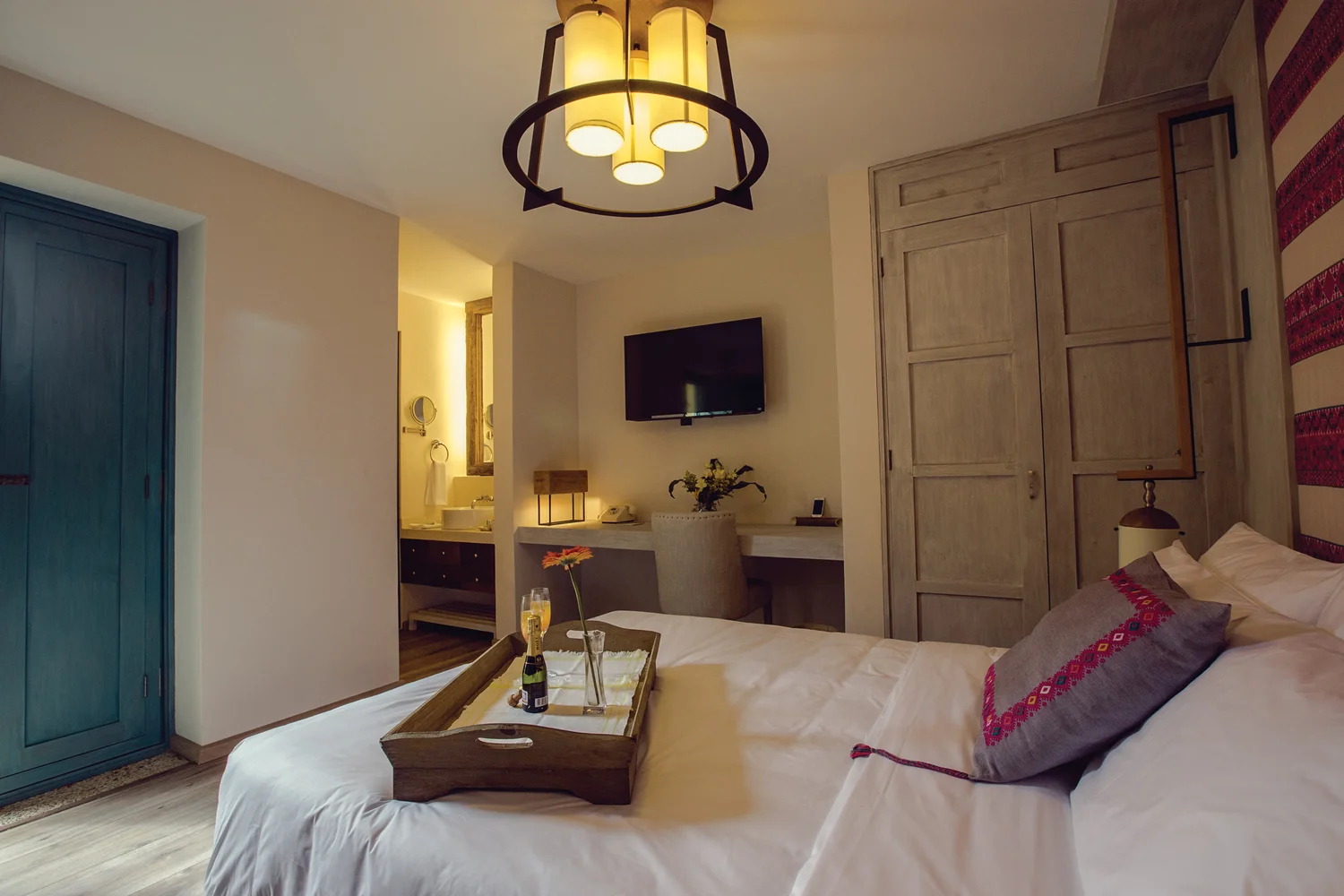 Guestroom with a custom lantern pendant above the bed