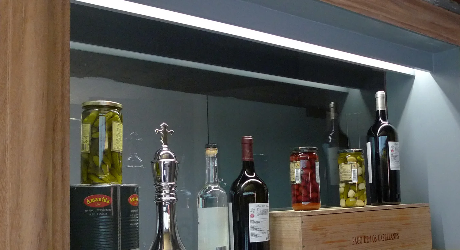 Lighting detail — sconces and shelving along the dining wall