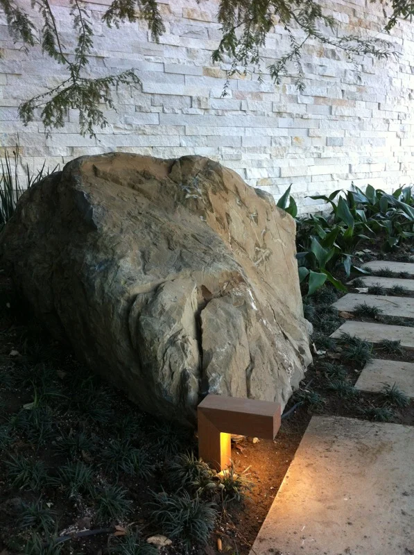 G Site — lit stone path winding through the planting