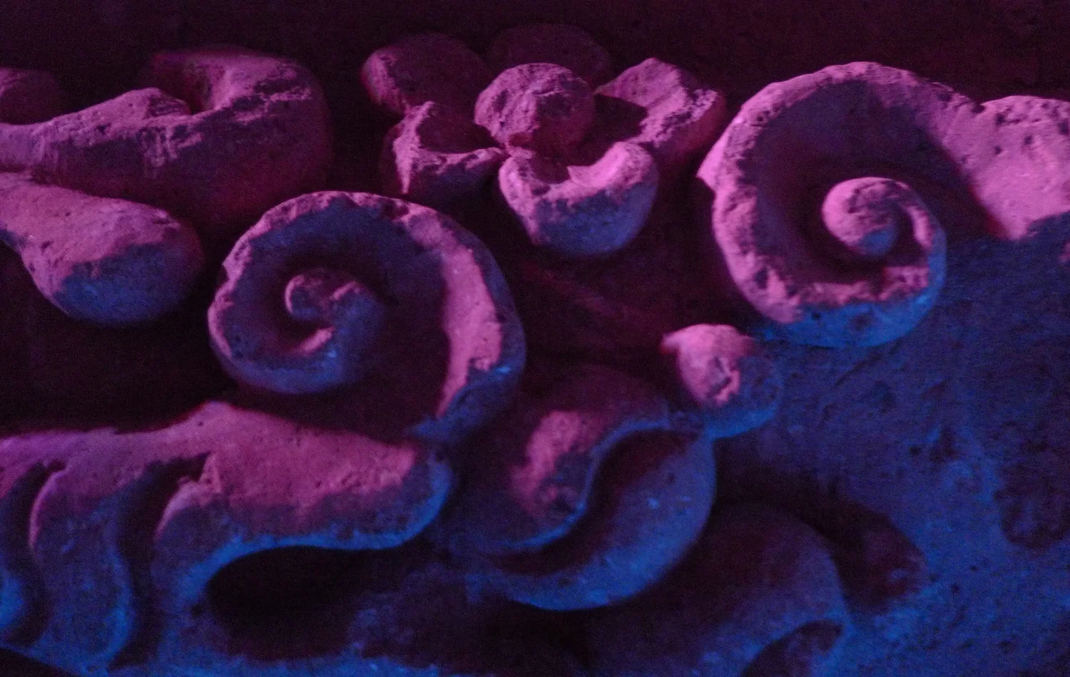Carved baroque ornament graded from pink into blue