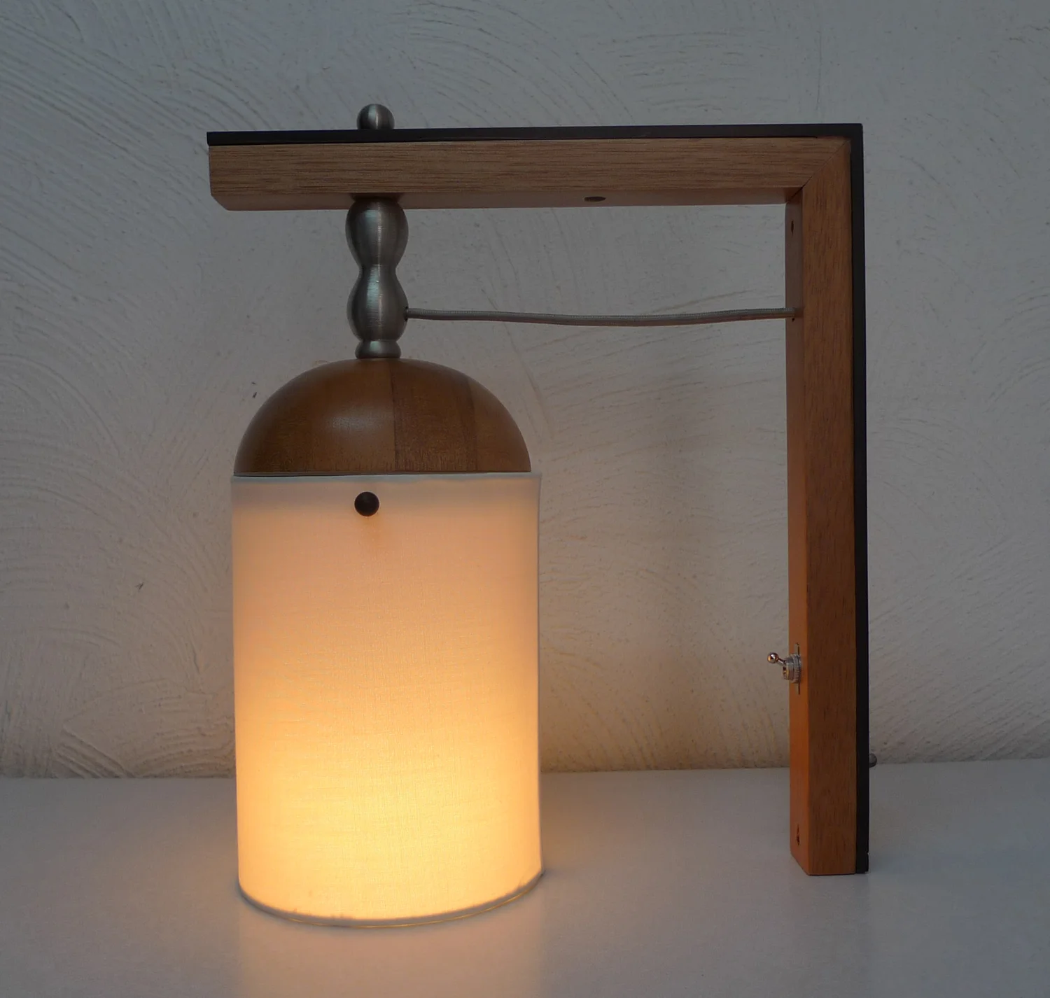Lum — fixture mounted beside the bed