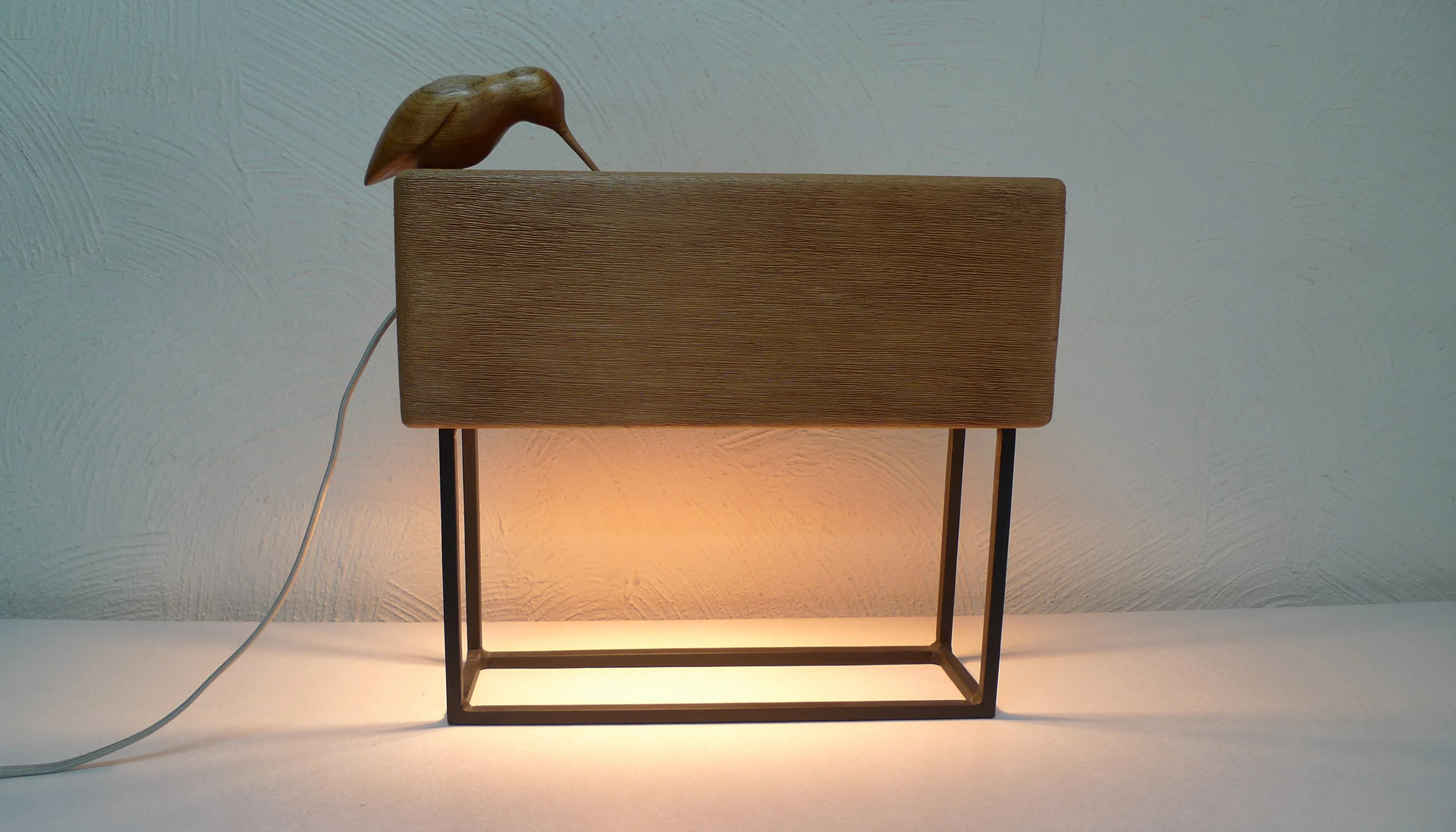 Totem — wooden shade fixture with a perched Maya bird sculpture