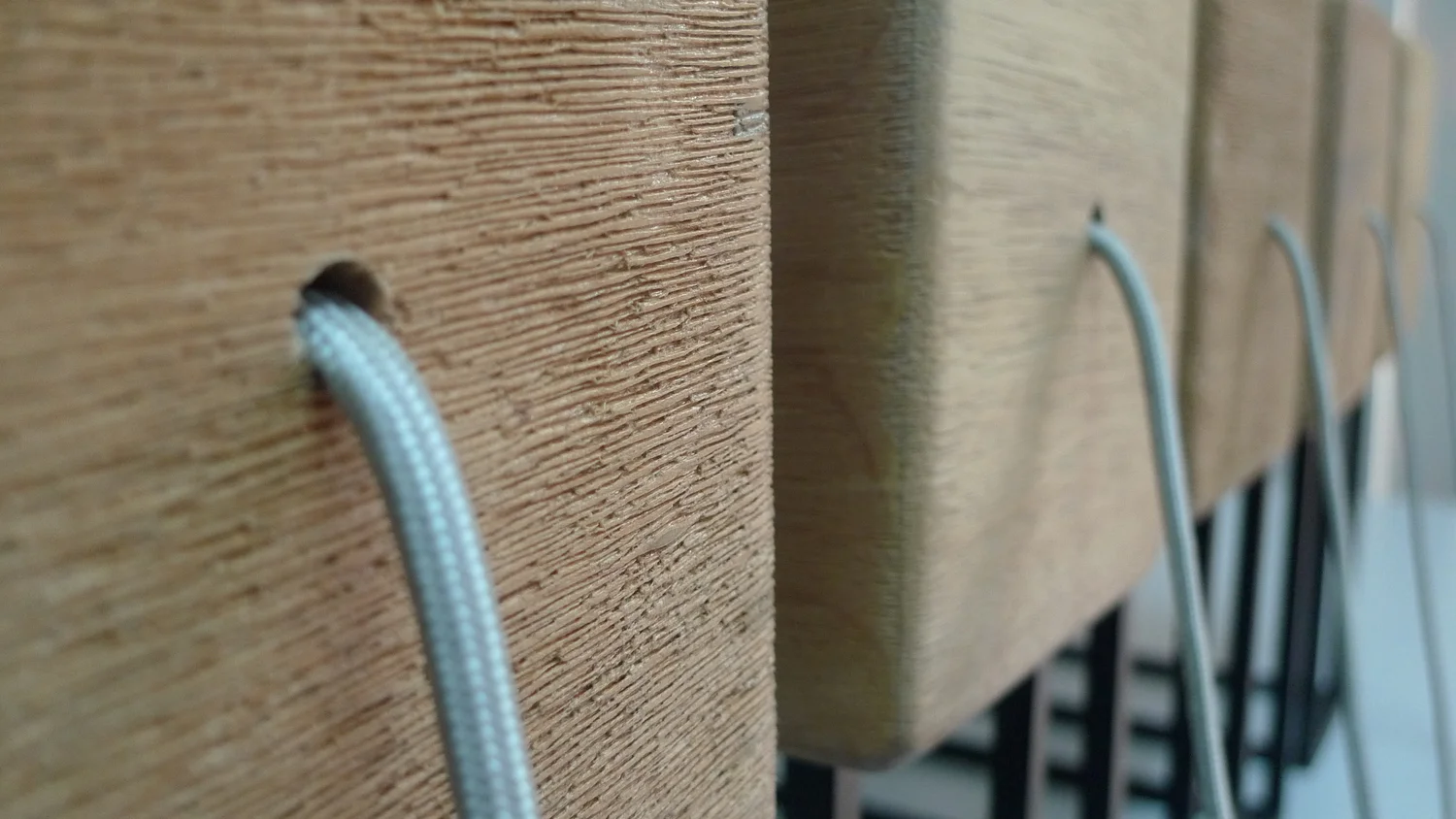 Totem — close detail of the wood grain and cable entry